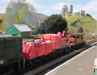  ?? ANDREW P.M. WRIGHT ?? ‘T3’ No. 563 is dragged into Corfe Castle by a diesel shunter soon after its arrival at the Swanage Railway on April 12. As reported last issue, the ‘Purbeck Line’ hopes to return the Nine Elms-built 4-4-0 to steam.