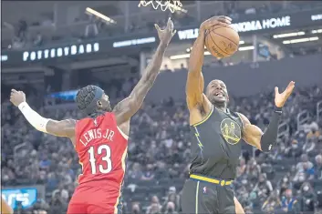  ?? JEFF CHIU — THE ASSOCIATED PRESS ?? Golden State Warriors forward Andre Iguodala (9) grabs a rebound next to New Orleans Pelicans guard Kira Lewis Jr. (13) during the first half Friday in San Francisco.