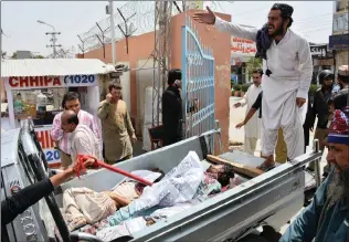  ?? PICTURE:AP ?? Volunteers rush the injured to hospital yesterday after a suicide bomber struck outside a crowded polling station in Pakistan’s south-western city of Quetta, killing dozens of people as the country voted in a general election, marking the second...