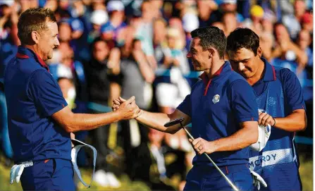  ?? STUART FRANKLIN/GETTY IMAGES ?? Ian Poulter (left) and Rory McIlroy celebrate during Europe’s sweep of the afternoon foursome matches Friday at the Ryder Cup in France. It was the first time Europe swept a session since 1989, and the first time ever at the Ryder Cup in foursomes.