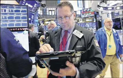  ?? AP PHOTO ?? Trader Edward Curran works on the floor of the New York Stock Exchange on Friday. U.S. stocks fell with other markets around the world on Friday after the Trump administra­tion stepped up the trade dispute between the world’s two biggest economies by...