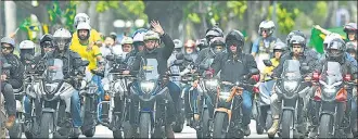  ?? AFP ?? PRESIDENT ON WHEELS: Brazilian President Jair Bolsonaro waves as he heads a massive motorcade rally with his supporters down the streets of Rio de Janeiro on Sunday. His public rallies and motorcades have often been criticised as the country struggles to contain the Covid-19 pandemic.