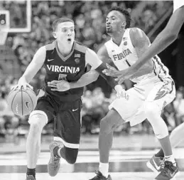  ?? STEVE CANNON/ASSOCIATED PRESS ?? Virginia's Kyle Guy (13 points) works against the defense of FSU’s Braian Angola.
