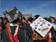  ?? PAUL POST -MEDIANEWS GROUP ?? Graduates conveyed funny messages such as “Stoked & Broke” and “All I Need is My Cat and Coffee” on their mortar boards.