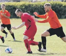  ??  ?? BATTLE FOR THE BALL: Sean Exley closes down a Boro Rangers man