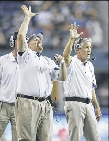  ?? JOHN FROSCHAUER / ASSOCIATED PRESS ?? Dan Quinn (left) used to coach defensive line for Seattle’s Pete Carroll (right). Now as head coach of the Falcons, he’ll try to end the season for his former boss and team today in an NFC divisional playoff game.