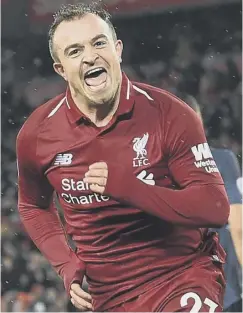  ?? PICTURE: PAUL ELLIS /AFP/GETTY ?? 2 Liverpool’s Xherdan Shaqiri celebrates putting the home team 3-1 ahead and out of sight of a Manchester United side that looked bereft of ideas