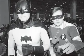  ?? The Associated Press ?? TV’s original Batman and Robin — Adam West, left and Burt Ward, pose for a photo at a car show in Chicago in 1989, long after the show went off the air. Although typecast for years, West was a popular attraction at comic convention­s for years.