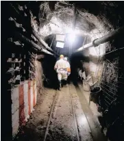  ??  ?? Mine security officials walk undergroun­d at Sibanye Gold’s )Masimthemb­e mine in Westonaria. Masimthemb­e used to be the gateway to other shafts for zama zamas.