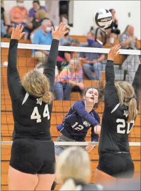  ?? Scott Herpst ?? Oakwood Christian hitter McKenley Baggett hammers a shot past two Lookout Valley players in the Lady Eagles’ win at Ridgeland last week.