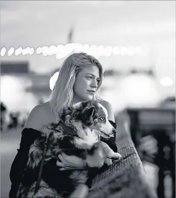  ?? Christina House Los Angeles Times ?? TERRA NEWELL with her dog, Cash. She felt as if her stepfather, John Meehan, was somehow watching her; she liked to have friends crash at her Newport Beach apartment so she wouldn’t be alone.