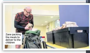  ??  ?? Zane packing the meals to deliver to the children