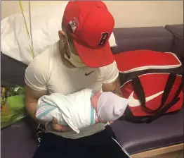  ?? Courtesy photo ?? Jorge Valencia holds his newborn son, Jayden, at the hospital. Valencia died in a single-vehicle crash. Maritza Ortega, Valencia’s girlfriend and mother of Jayden, described Valencia as hard working and wanting to provide for his family.