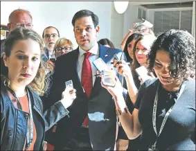  ?? AP/JACQUELYN MARTIN ?? Sen. Marco Rubio, R-Fla., is surrounded Thursday by reporters as he leaves a briefing at the Capitol of the full Senate by Deputy Attorney General Rod Rosenstein, amid controvers­y over President Donald Trump’s firing of FBI Director James Comey.