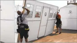  ?? PALLET SHELTER ?? Pallet Shelter workers assemble a unit in Fresno in 2020.