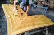  ?? SUBMITTED ?? Charlie Carney works on a wood table. His new business American Live Edge is located at 218 Main St. in Painesvill­e.