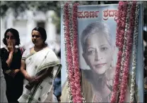  ?? PICTURE: AP ?? Mourners stand next to a portrait of Indian journalist Gauri Lankesh during the public viewing of her body in Bangalore.