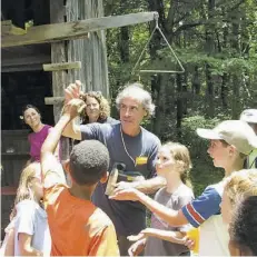  ?? COURTESY PHOTOS ?? Lyt Wood and the Rappahanno­ck Nature Camp in its first year of 1986. Above: Campers vying for a chance to hold a huge dragonfly held by Lyt.