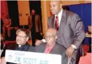  ??  ?? Bellwood Mayor Andre F. Harvey presents J. W. Scott with a memento of the street renamed in his honor.
| JOHN FOUNTAIN PHOTO