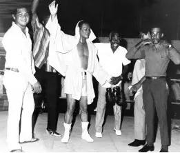  ??  ?? In this file photo from Saturday, October 16, 1971 Willie Yap (second left), then a featherwei­ght boxer, raises an arm victorious­ly after his split decision win over Wendell Spence in a 10 round battle at the Dragon Gym in Kingston. Yap passed away in London, England, on May 11.