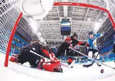  ?? AFP ?? Finland’s Riikka Valila (right) scores a goal past Canada’s Haley Irwin in the women’s preliminar­y round ice hockey match.