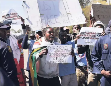  ??  ?? Anti-Mugabe demonstrat­ors protest against Zimbabwean First Lady Grace Mugabe, in Pretoria, South Africa, yesterday as tensions rise over allegation­s that she assaulted a young model at a luxury hotel in Johannesbu­rg.