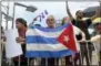  ?? LESLIE OVALLE — SOUTH FLORIDA SUN-SENTINEL VIA AP ?? Nelson Avila, center, joins anti-President Donald Trump protesters, calling for open relations with Cuba on Friday in Miami. Trump thrust the U.S. and Cuba back on a path toward open hostility Friday with a blistering denunciati­on of the island’s...