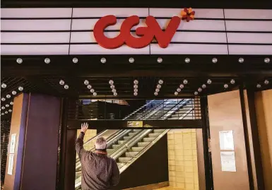  ?? Jessica Christian / The Chronicle ?? General manager Michael Spring lifts the gates at CGV San Francisco 14 theater on Van Ness Avenue.