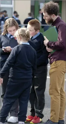  ?? Photo by Domnick Walsh ?? Pupils of Murhur National School, Moyvane on the hunt for Easter Eggs last week with a little help from teacher.