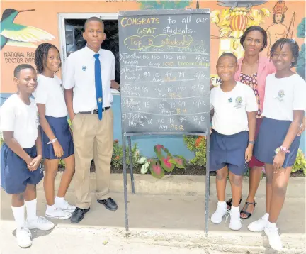  ??  ?? Jonathan Morgan (third from left), head boy of Hosanna Preparator­y School in Montego Bay, St James, with his Grade Six teacher Shammy Green-Dawkins (second right) and the school’s other four top performing students, from left: Joshua Waite, Anaijha Powell, Nathan Morris and Jada Glenn. Jonathan has distinguis­hed himself by achieving a 100 per cent average in all five of the Grade Six Achievemen­t Test’s focus subjects.