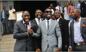  ?? AP file photo ?? Kyagulanyi Ssentamu (center), a Ugandan pop star known as Bobi Wine, celebrates in Kampala, last year after being sworn in as a member of parliament.