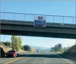  ?? Courtesy photo / John Latorre (above); Courtesy photo / Linda Benson (left) ?? A photo taken at 9:25 a.m. Wednesday shows a banner that says “No white guilt!” hanging from the west-facing side of the Highway 108 overpass near the Mono Way exit (top). A photo taken at 11:39 a.m. Wednesday (left shows the banner that many found offensive had been removed and replaced with an American flag.