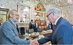  ??  ?? ICANA Iranian Parliament Speaker Ali Larijani (L) shakes hands with Janusz Lewandowsk­i, a member of the European Parliament, in Tehran on November 26, 2017.