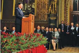  ??  ?? China’s President Xi Jinping addresses members of parliament and peers in Parliament’s Royal Gallery Tuesday, Oct. 20, in London. Britain and China toasted a “golden age” of relations with a state visit festooned with regal pomp and pageantry but...