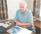  ?? Photo / NZME ?? Bonny Bodley pictured in 2006 looking over his book of his experience­s during World War II.