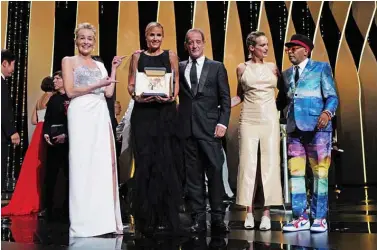  ??  ?? French director Julia Ducournau poses on stage with US actress Sharon Stone, French actor Vincent Lindon, French actress Agathe Rousselle and US director and Jury President of the 74th Cannes Film Festival Spike Lee after she won the Palme d’Or for her film “Titane” during the closing ceremony of the 74th edition of the Cannes Film Festival on Saturday. — AFP photos