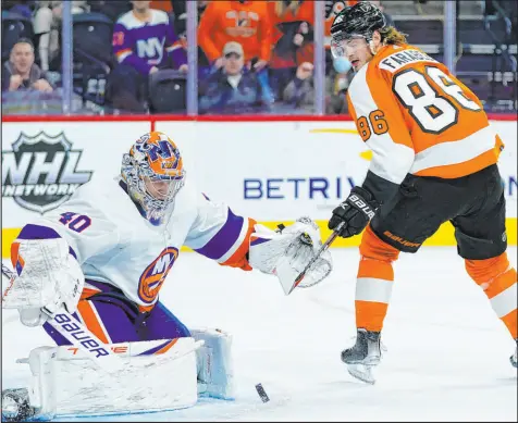  ?? Matt Slocum The Associated Press ?? Joel Farabee of the Flyers tries to get a shot past Islanders goaltender Semyon Varlamov during overtime at Wells Fargo Center. The Islanders won 4-3 in a shootout Tuesday.