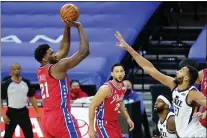  ?? MATT SLOCUM - THE ASSOCIATED PRESS ?? 76ers center Joel Embiid, left, puts up a shot over Utah’s Rudy Gobert last Saturday while Ben Simmons, center, looks on. If the 76ers are going to make a run at the NBA title, Embiid and Simmons have to stay healthy.