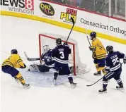  ?? Steve Musco/Contribute­d photo ?? Quinnipiac’s Sam Lipkin, No. 28, scores his second goal of the game just 37 seconds after his first goal, to give the Bobcats a 3-2 lead over Yale on Feb. 17.
to Quinnipiac claiming the ECAC men’s hockey regular-season championsh­ip for the third year in a row, and fifth time in a decade. As a bonus, the Bobcats beat rival Yale before a packed house at M&T Bank Center in Hamden, coming back from a 1-0 deficit to claim the Cleary Cup with a 5-1 win.