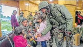  ?? PTI ?? An army officer offering juice to children after a rescue mission in Gulmarg in north Kashmir on Sunday.
