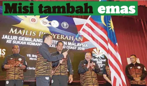  ?? Khairy Jamaluddin ?? KHAIRY menyerahka­n Jalur Gemilang kepada Ying How (dua dari kiri) di Kementeria­n Belia dan Sukan, semalam. Sasaran di bawah Program Podium adalah ranking 10 terbaik keseluruha­n. Bermaksud sasaran daripada segi pingat emas adalah mesti sekurang-kurangnya melebihi dari Glasgow iaitu melebihi enam emas”