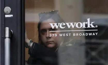  ??  ?? A woman exits a WeWork co-working space in New York City. Photograph: Brendan McDermid/Reuters