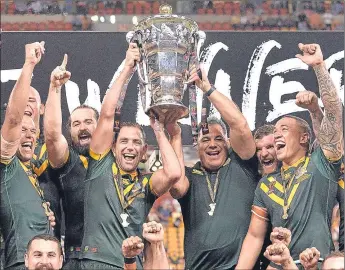  ??  ?? Australia, along with boss Mal Meninga, celebrate their World Cup victory