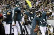  ?? MATT ROURKE — THE ASSOCIATED PRESS ?? Philadelph­ia Eagles wide receiver Nelson Agholor (13) celebrates with teammates after catching a touchdown pass form quarterbac­k Carson Wentz, second from left, during the second half of Monday’s game against the Washington Redskins.