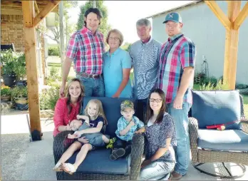  ?? CAROL ROLF/CONTRIBUTI­NG PHOTOGRAPH­ER ?? The Terry Small family of Hector is the 2017 Pope County Farm Family of the Year. Family members include, front row, from left, Hailey Wilbanks Small; Natalie Small, 5, holding her 3-month-old cousin, Emmett Small; Corbin Small, 2; and Kala Reece Small; and back row, from left, Eric Small, Gail Small, Terry Small and Cory Small. The family raises cattle, poultry and hay.