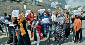  ?? —
AFP ?? Afghan women take part in a protest march for their rights under the Taliban rule in the downtown area of Kabul on Friday.