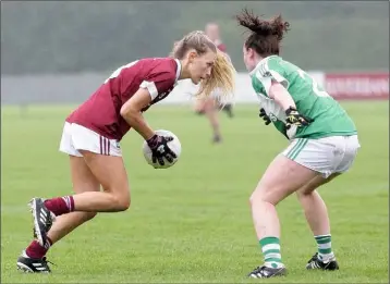  ??  ?? Ellen Barrett of St. Martin’s taking on Clonguish defender Oonagh McGowan.