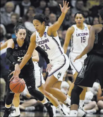  ?? Jessica Hill The Associated Press ?? Connecticu­t forward Napheesa Collier steals the ball from St. Francis guard Jessica Kovatch during the Huskies’ 140-52 victory Saturday.