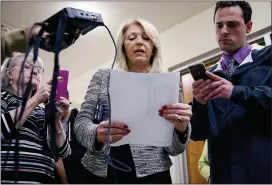  ?? ASSOCIATED PRESS FILE PHOTO ?? Mesa County Clerk Tina Peters, center, reads the results from the first round of ballots for the 2020presid­ential primary elections at the Mesa County election office in Grand Junction, Colo.