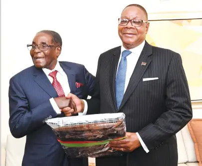  ??  ?? President Mugabe shares a lighter moment with his Malawian counterpar­t President Peter Mutharika on the sidelines of the 72nd Ordinary Session of the United Nations General Assembly in New York yesterday. — (Picture by Presidenti­al Photograph­er Joseph...